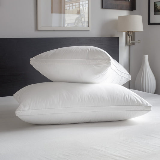 Astra Gusseted Down Alternative Pillow by Downright, styled on a bed