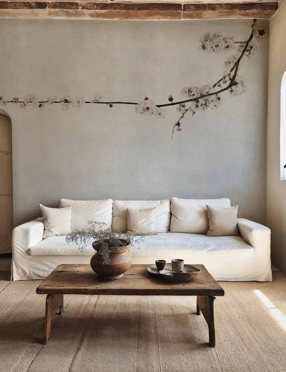 Blossom mural by Coordonné in Branch Grey, shown in a styled room