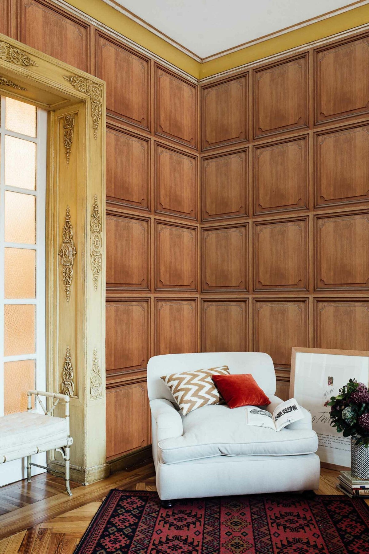 Boiserie wallpaper by Coordonné in Goji, shown in a styled room