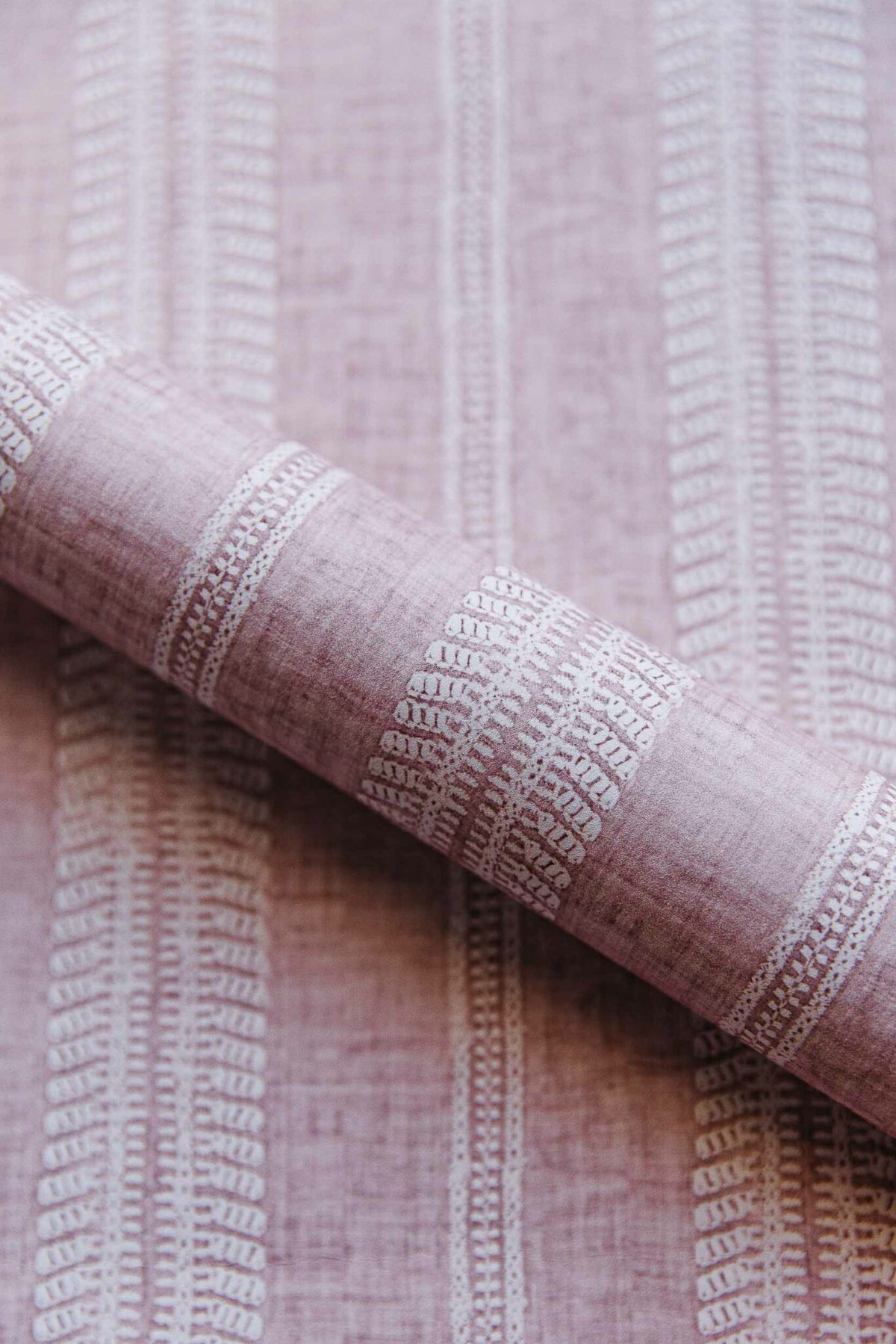 Costura wallpaper by Coordonné in Cava/Rosa, shown in a styled room