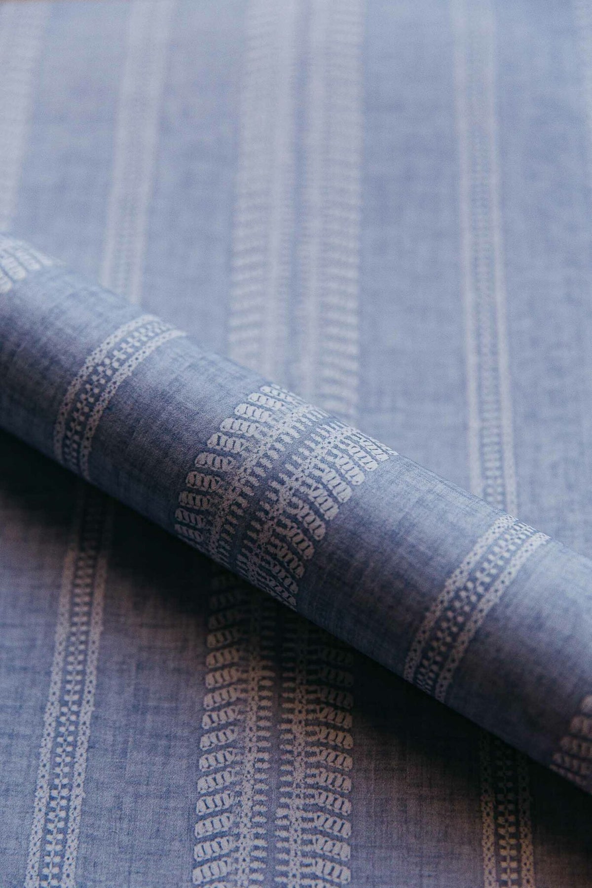 Costura wallpaper by Coordonné in Ceruleo, shown in a styled room