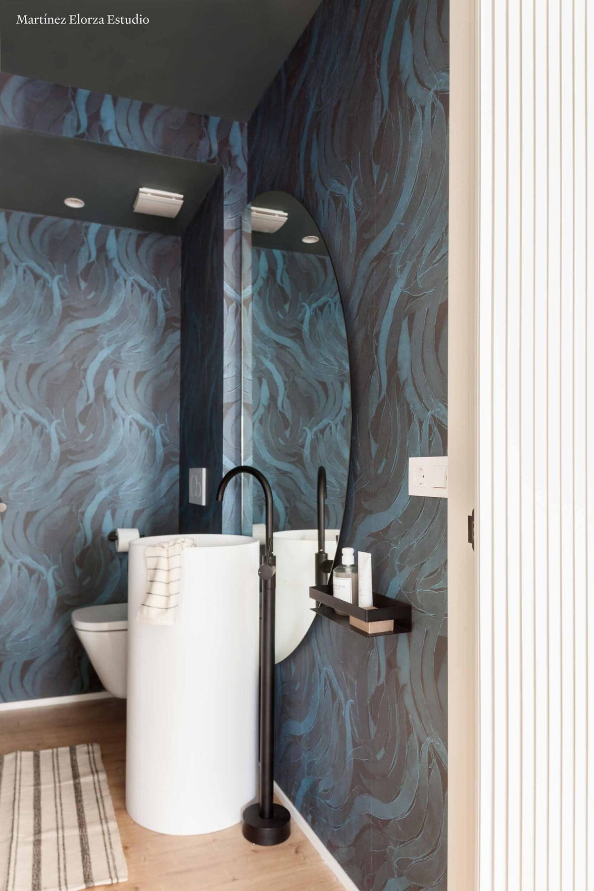 Crop Fossils wallpaper by Coordonné in Sapphire, shown in a styled room