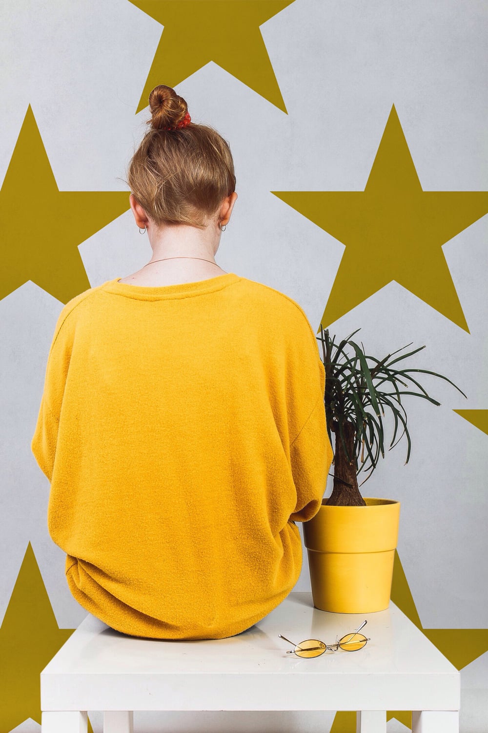 Hollywood wallpaper by Coordonné in Mustard, shown in a styled room