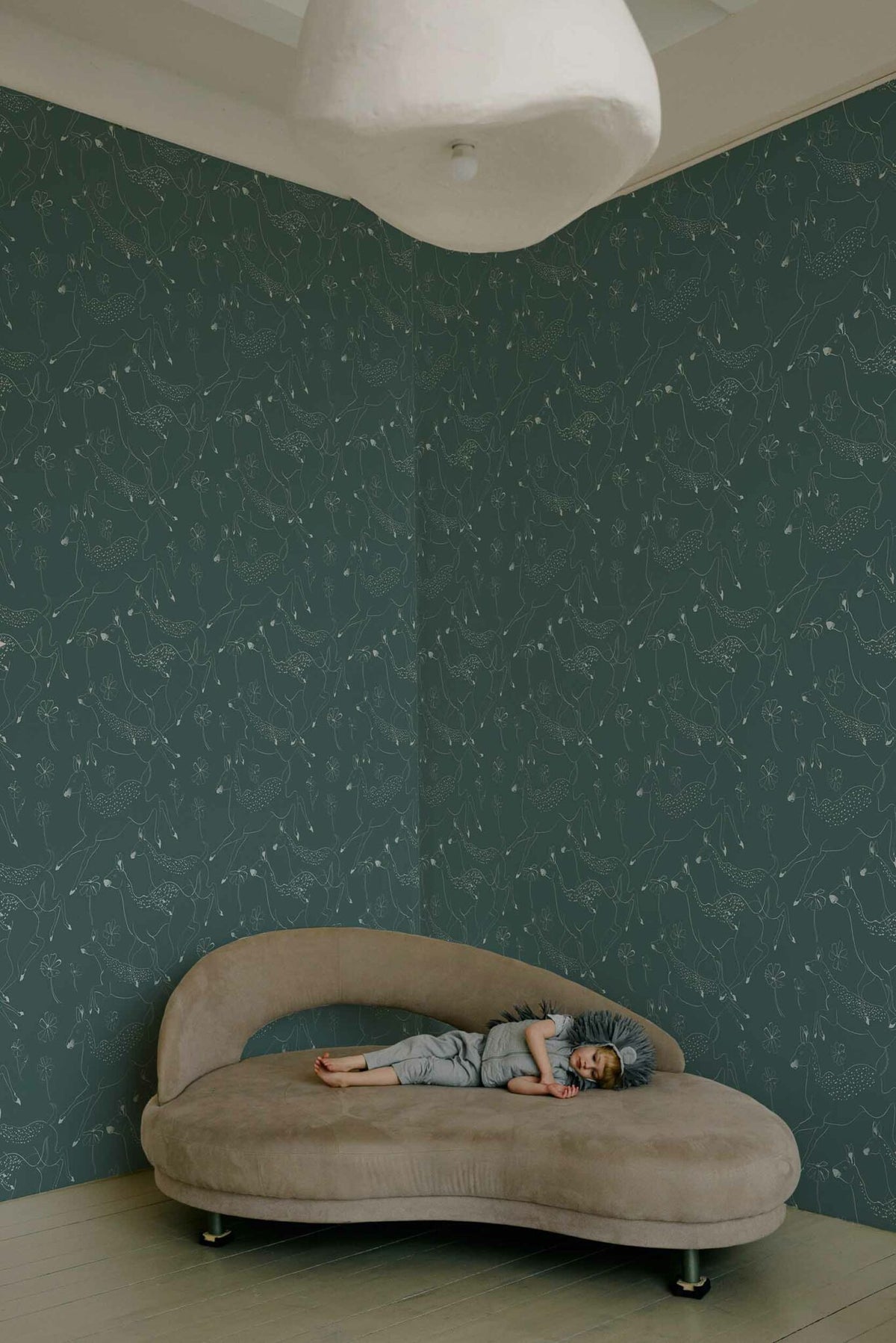 Jumping Bambis wallpaper by Coordonné in Aqua, shown in a styled room