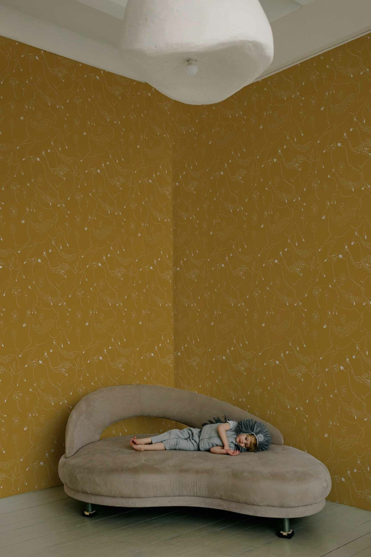 Jumping Bambis wallpaper by Coordonné in Curry, shown in a styled room