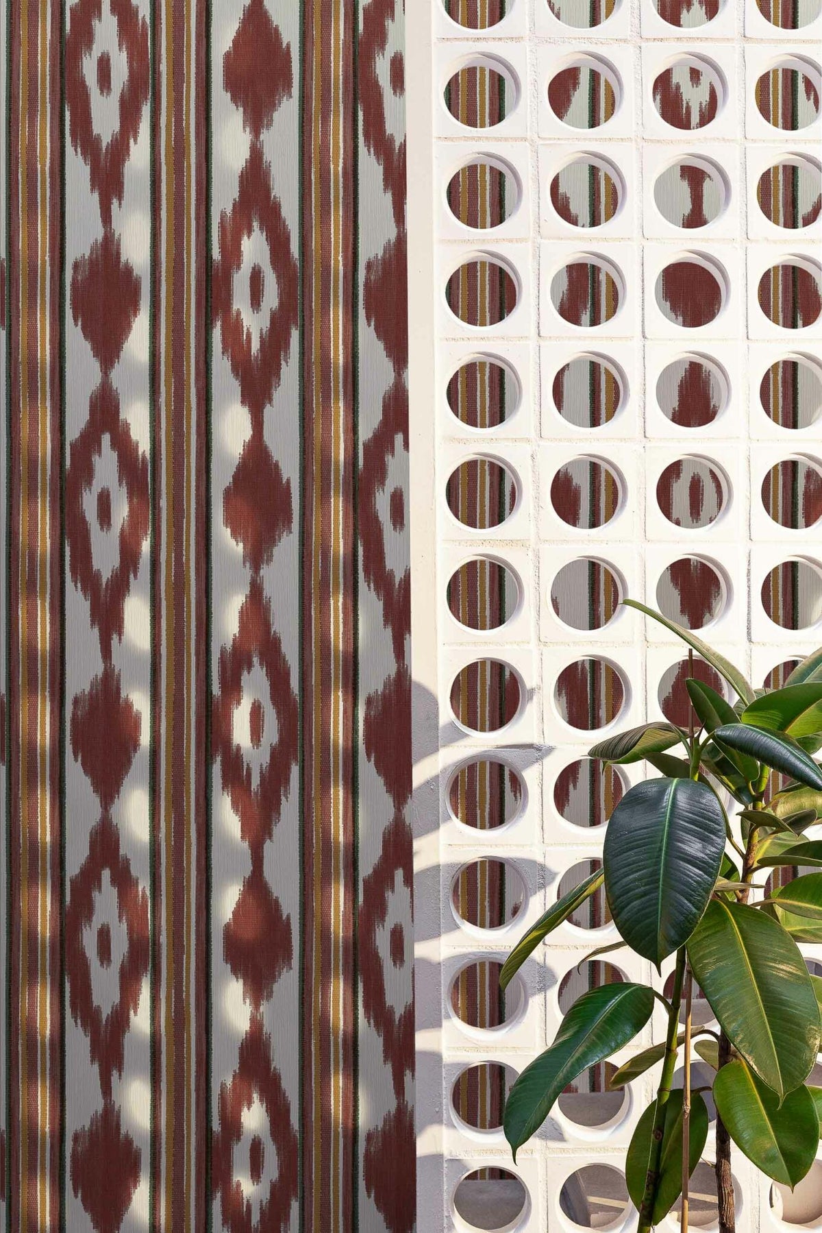Lloseta wallpaper by Coordonné in Wine, shown in a styled room