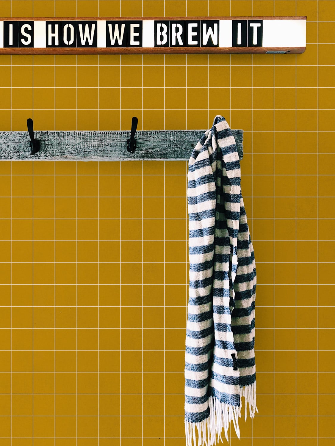 Notebook wallpaper by Coordonné in Mustard, shown in a styled room