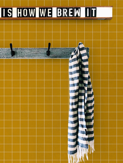 Notebook wallpaper by Coordonné in Mustard, shown in a styled room