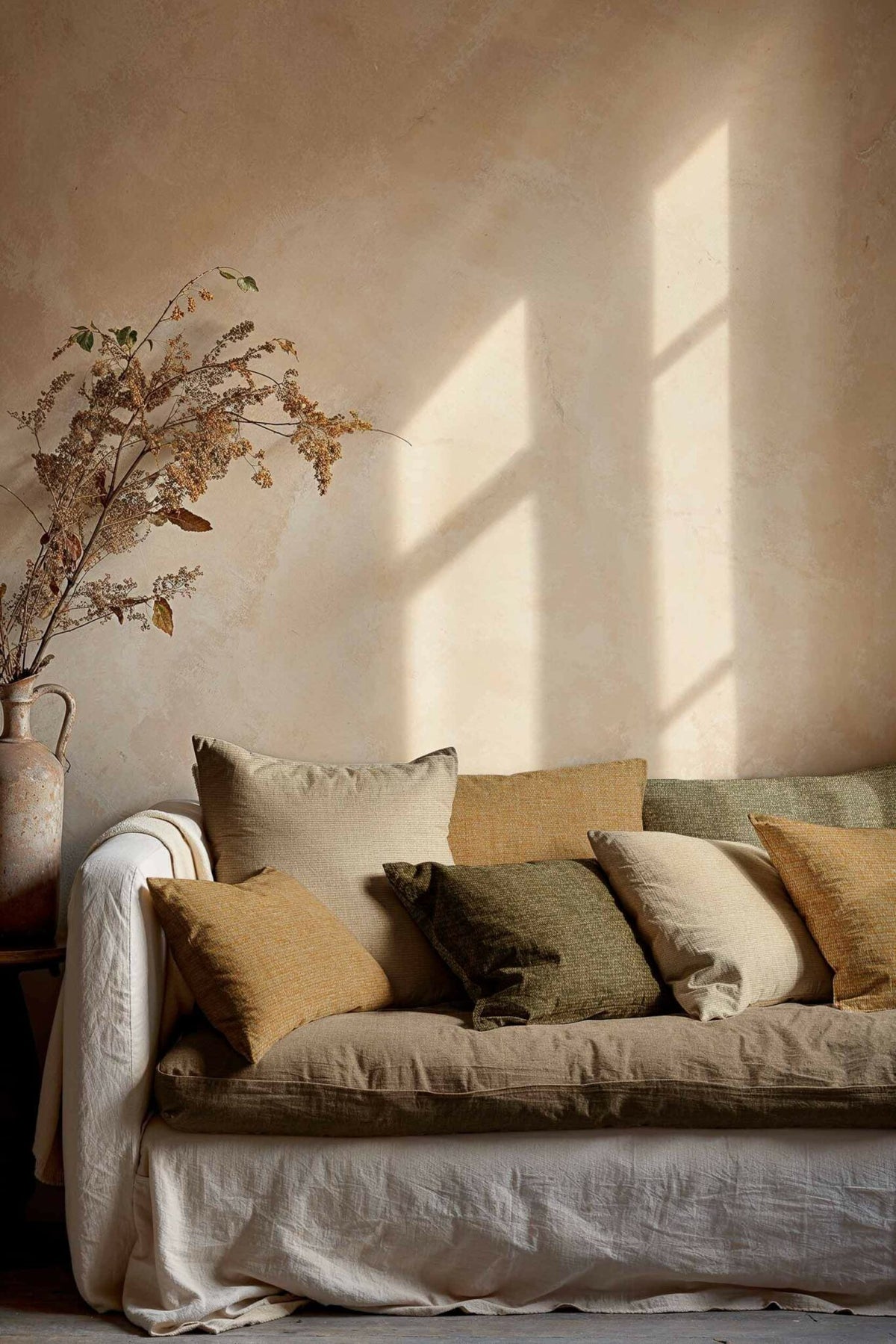 Plain Dune fabric by Coordonné in Leaf, shown in a styled room