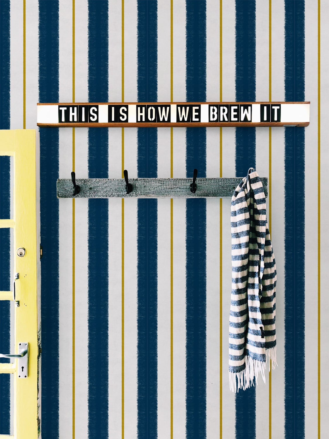 Race wallpaper by Coordonné in Navy, shown in a styled room