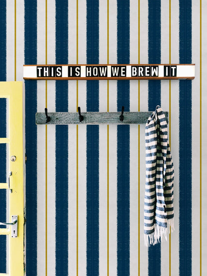 Race wallpaper by Coordonné in Navy, shown in a styled room