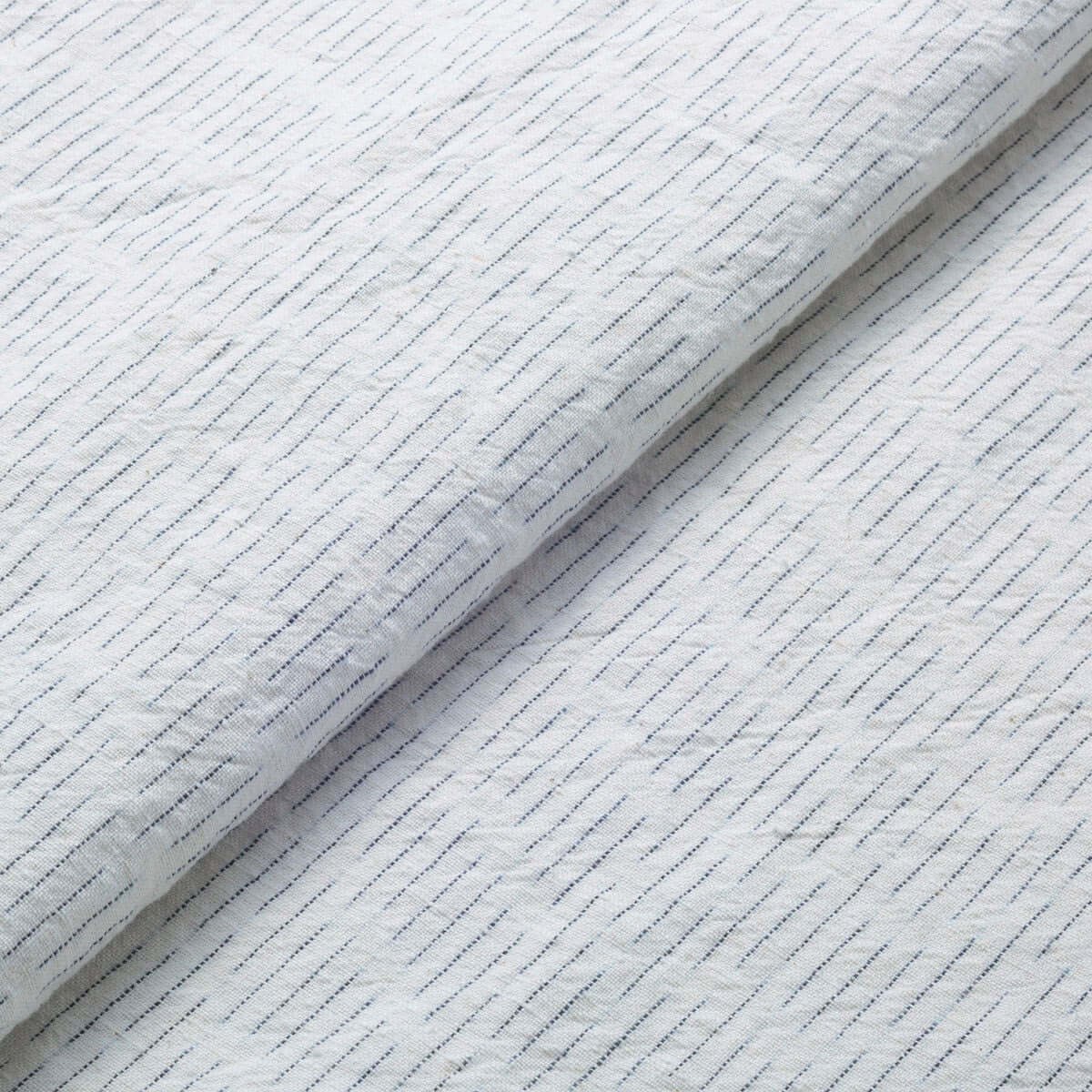 The ReBorn House TRH5779 Chiri-Gasuri Scattered Indigo Ikat Cotton in Shiro Ground, colorway TRH5779.B, flat fabric swatch