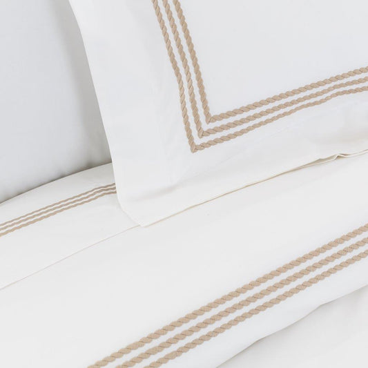 Windsor Sateen Sheet Set by Downright, styled on a bed