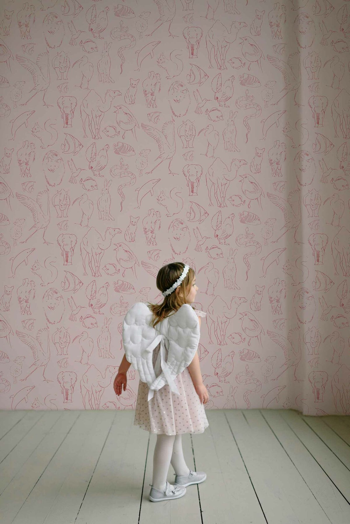 Zoology wallpaper by Coordonné in Candy, shown in a styled room
